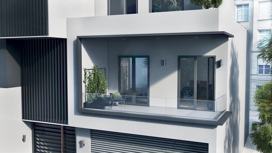 Exterior facade of a building with glass balustrade and hinged ALUMIL windows in grey color.