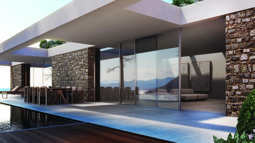 Πολυτελής μονοκατοικία με πέτρινους τοίχους και πισίνα, με συρόμενα κουφώματα αλουμινίου Alumil SUPREME S500 με minimal σχεδιασμό.