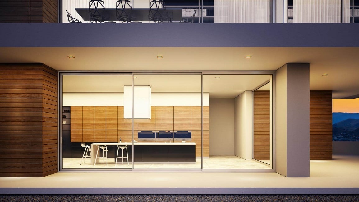 Night exterior shot of a luxury house, with Alumil sliding aluminium frames overlooking the minimal kitchen of the house. Night exterior shot of a luxury house, with Alumil sliding aluminium frames overlooking the minimal kitchen of the house.