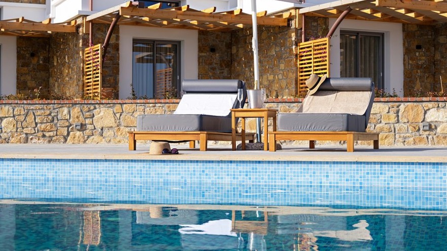 Close up to two sunbeds by the pool