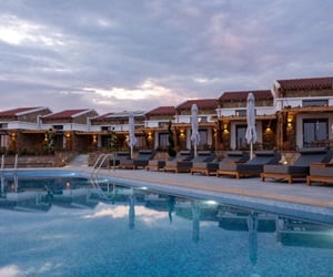 The pool area with the sunbeds at sundown