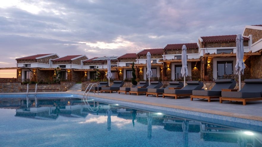 The pool area with the sunbeds at sundown