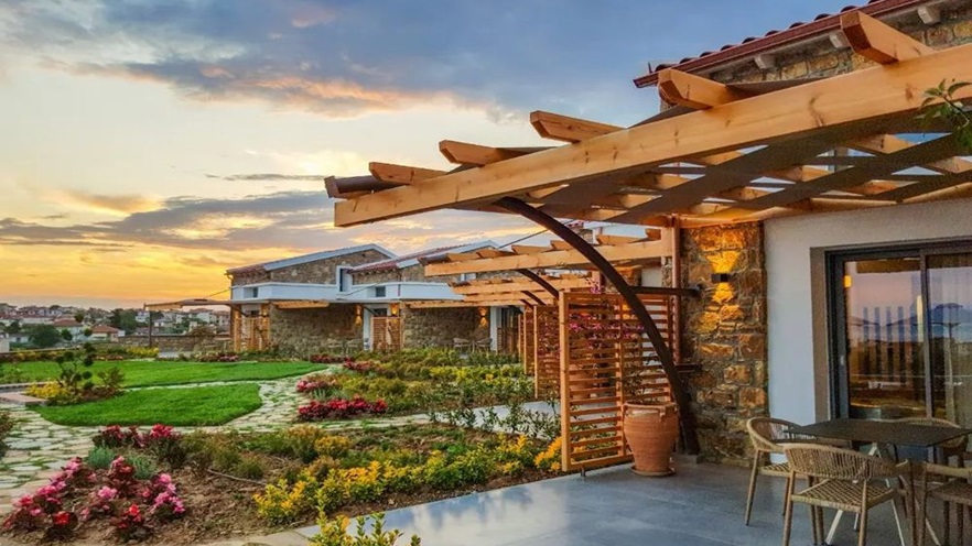 The rooms' terraces that overlook the garden at sundown