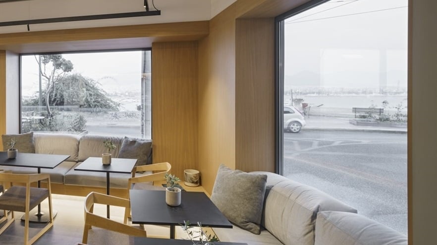 Sitting area with sofas, chairs and tables by the window