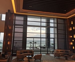 Large glass openings give a view from the lobby to the sea
