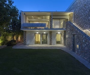 The residence viewed from the garden at night