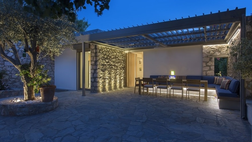 Outdoor sitting area under a pergola at night