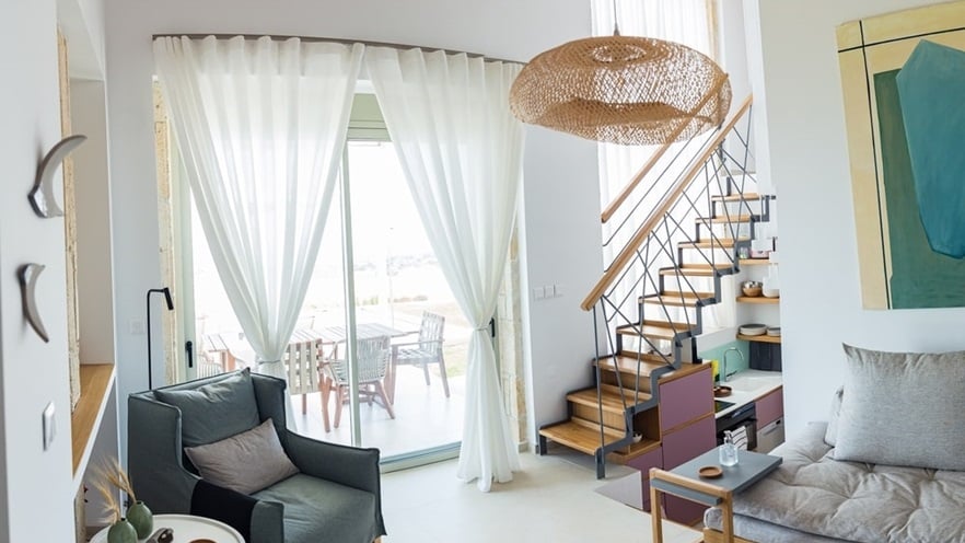 The cozy living room in white and pastel colors