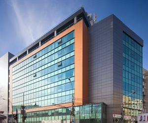 The building has glass facades and cladding