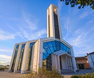The church is minimal with a tall bell tower