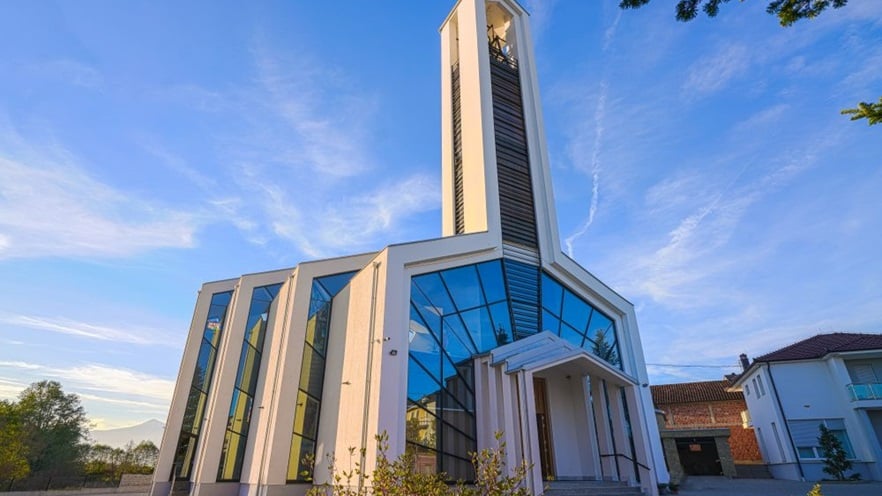 The church is minimal with a tall bell tower