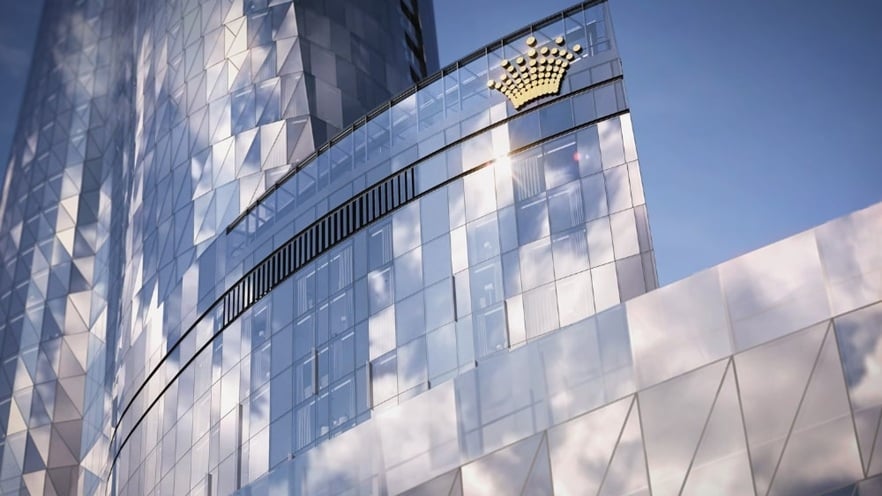 Close-up of Crown Sydney façade showing curved glass panels and the tower’s dynamic architectural form
