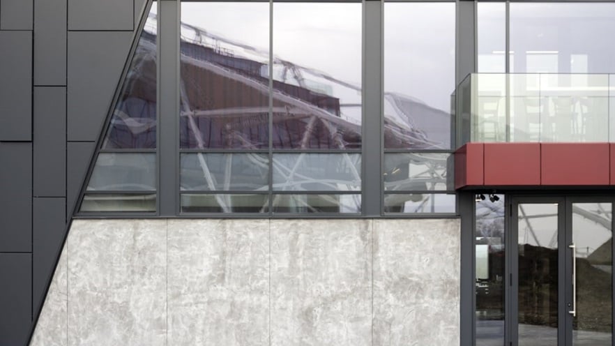 The curtain wall covers the building around the doors