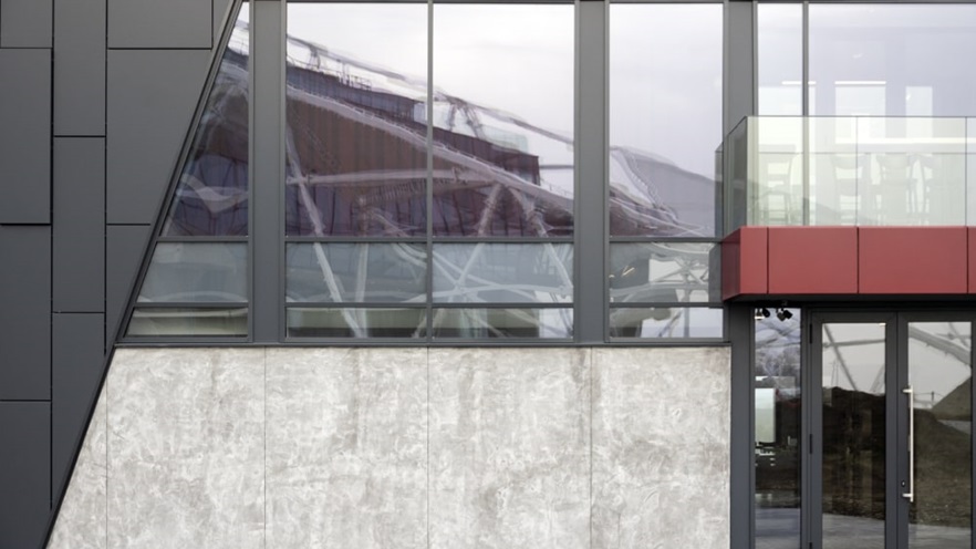 The curtain wall covers the building around the doors