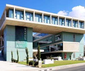 Facade of a university building featuring a modern design with large glass windows and aluminum framing
