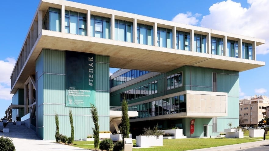 Facade of a university building featuring a modern design with large glass windows and aluminum framing
