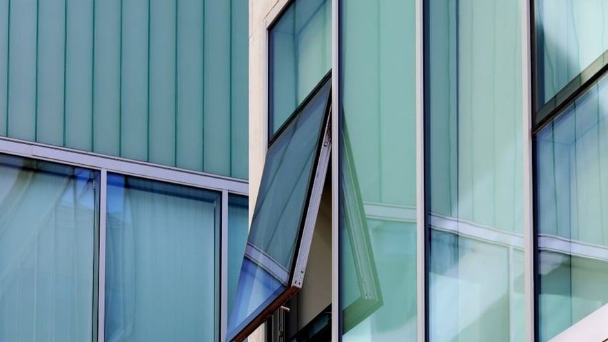 Close-up of an open window on a university building, showcasing aluminum curtain walls & an open window