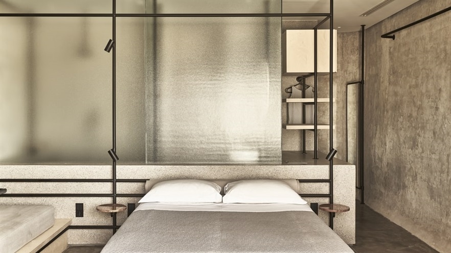 Bed with nightstands and a glass partition in the back