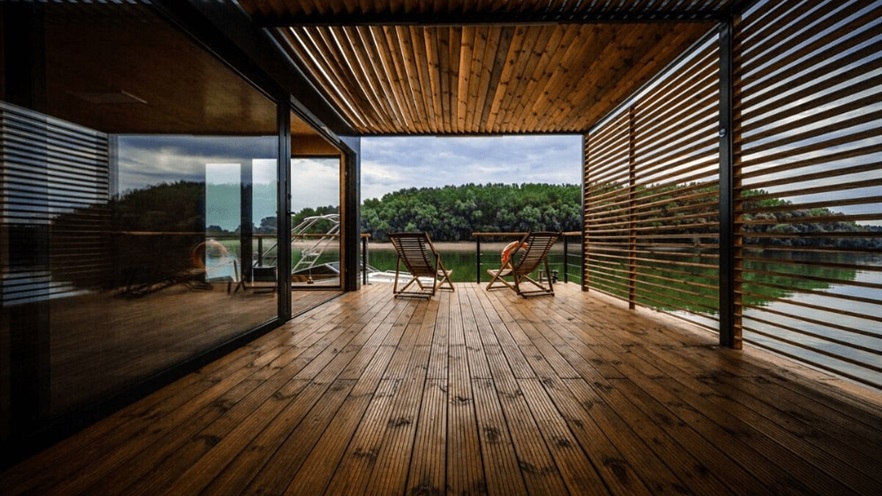 Enclosed terrace with pergola and open aluminum window