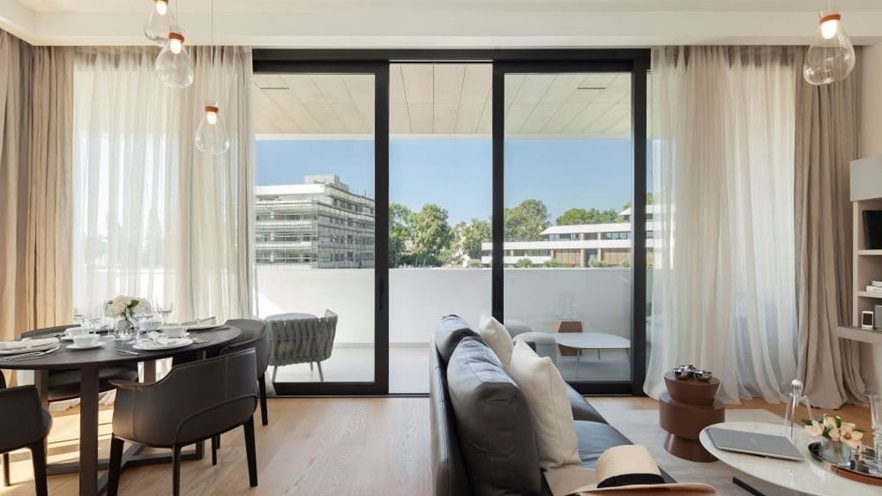 The living room opens to the balcony through the lift and slide Smartia S560