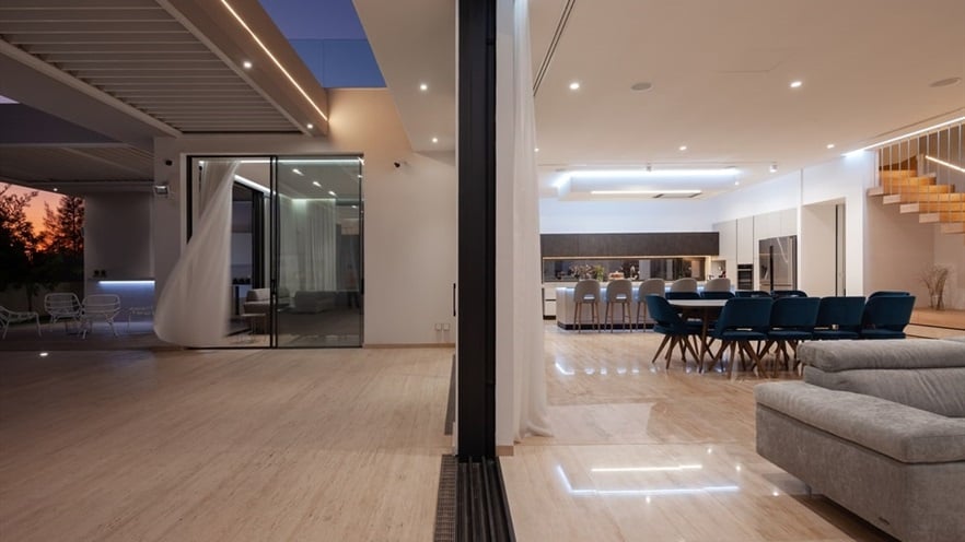 Open window with living room at one side and outdoor terrace on the other side
