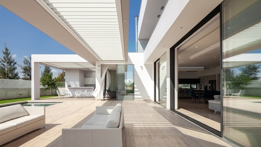 Terrace with sitting areas next to the living room open aluminum windows