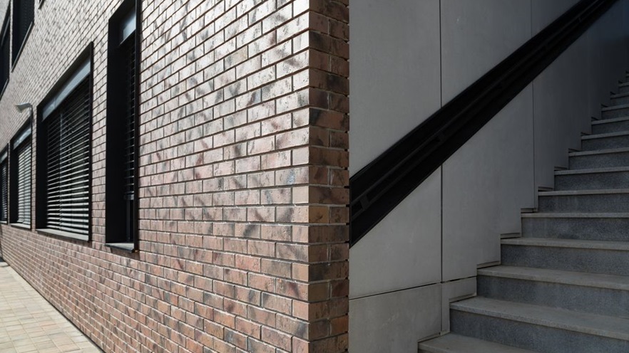 The building has a marble staircase leading to the upper levels