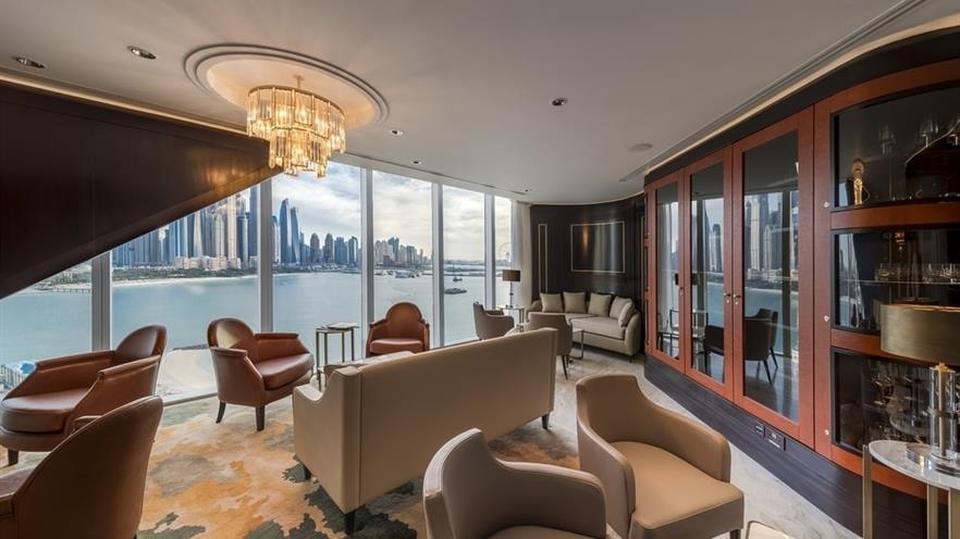 Sitting area in beige and brown colors with a view to the sea and the city