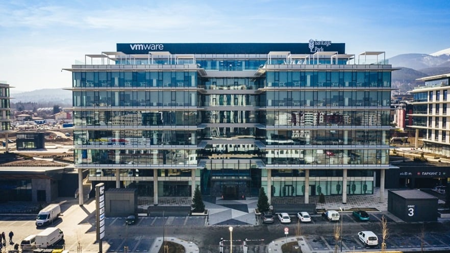 The multi storey building has curtain walls and a rooftop balcony