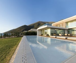 The house has a large terrace with a pool, overseeing the garden