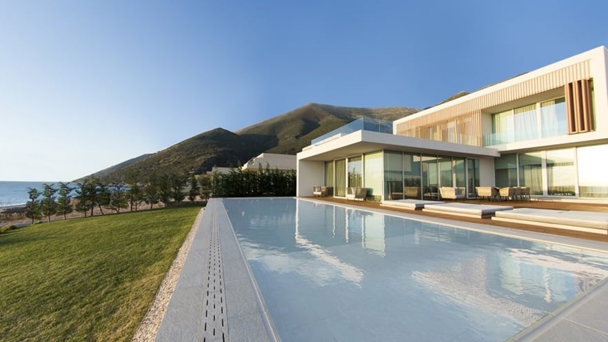 The house has a large terrace with a pool, overseeing the garden