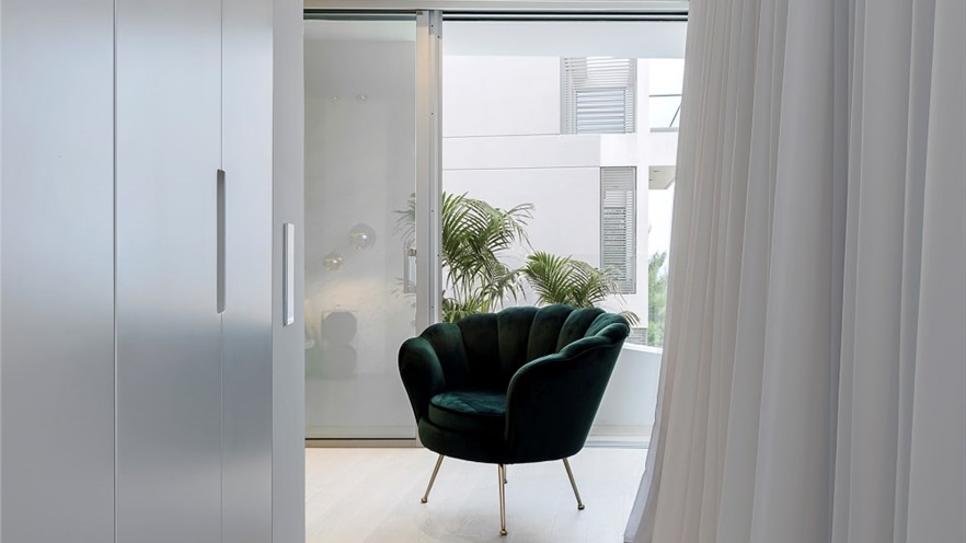 Stylish chair in white room with window and curtain