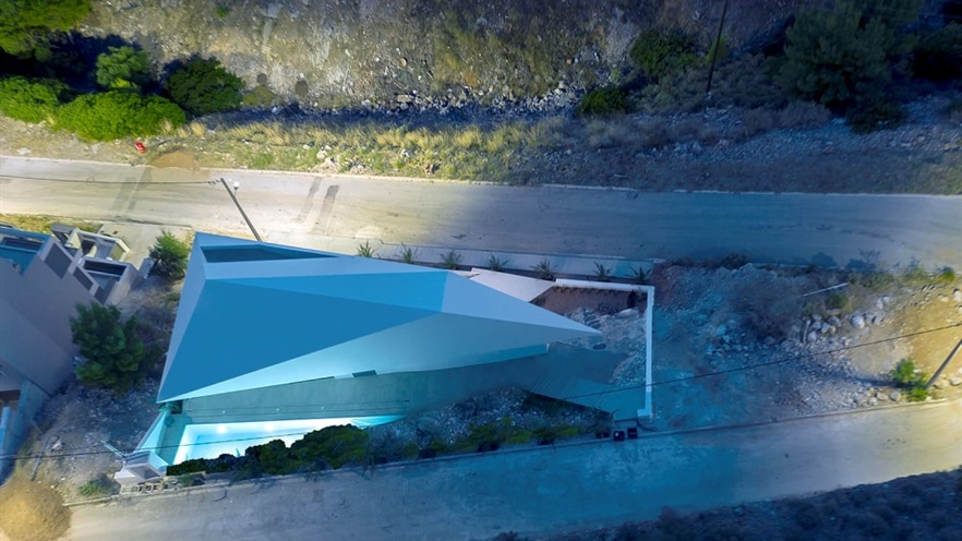 House at night from above, triangular house between two streets