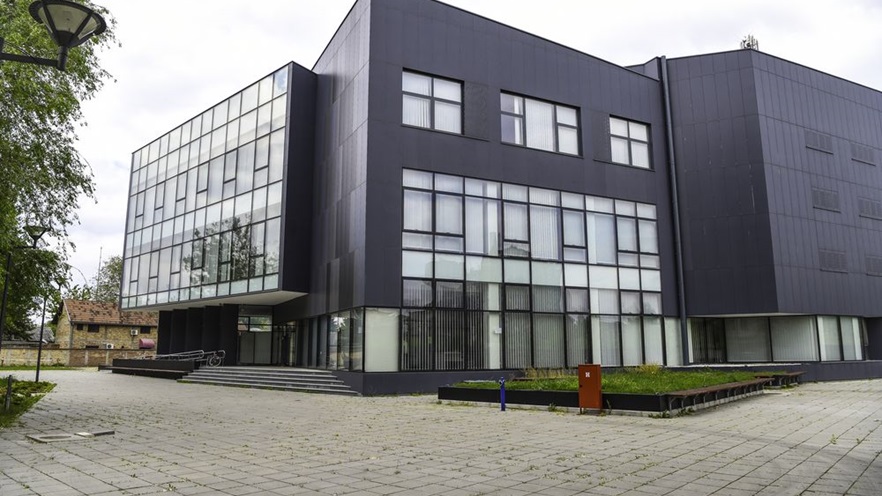 The building has parts covered with curtain wall and parts covered with cladding