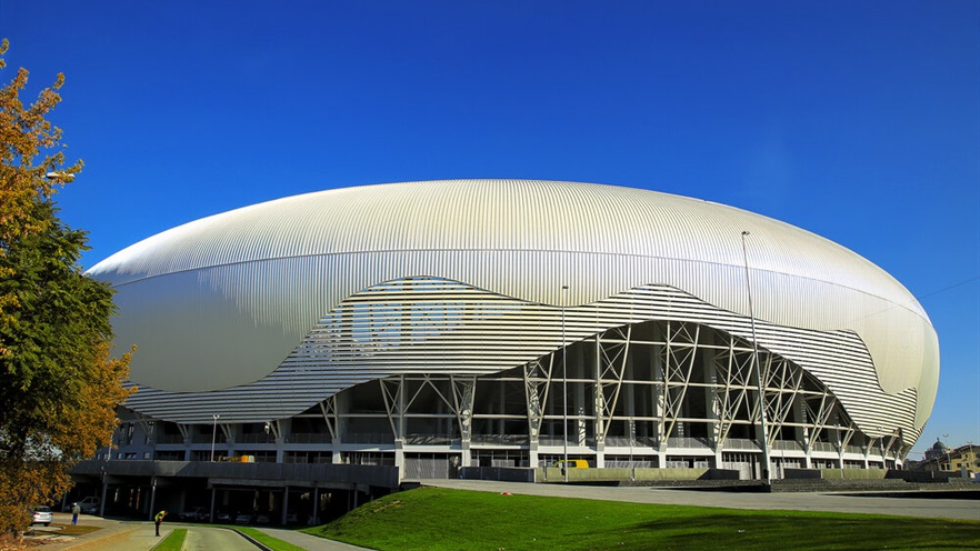 Walkway to the stadium through trees and grass