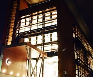 The building entrance at night with lights on