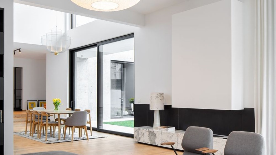 The sitting room has a large fireplace next to the sliding window