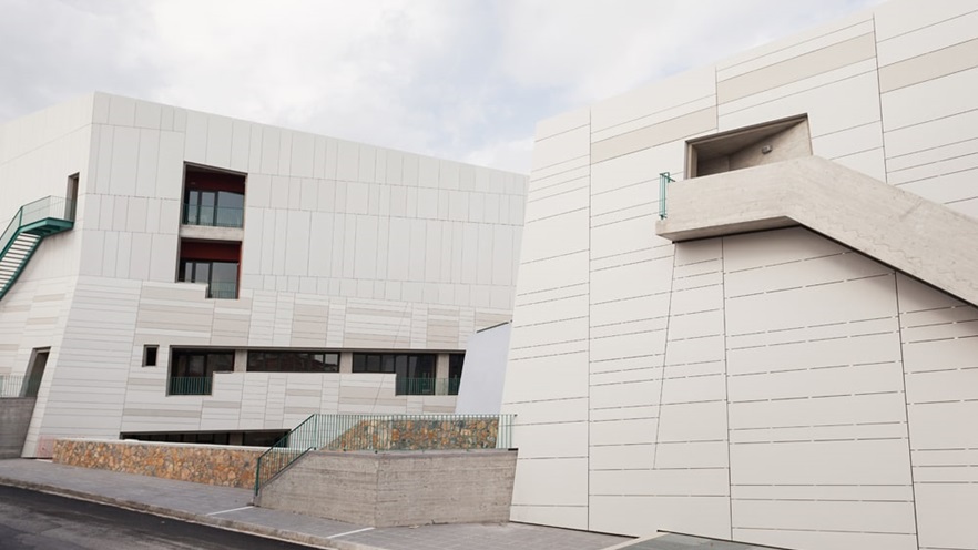 The building has concrete and metal external staircases