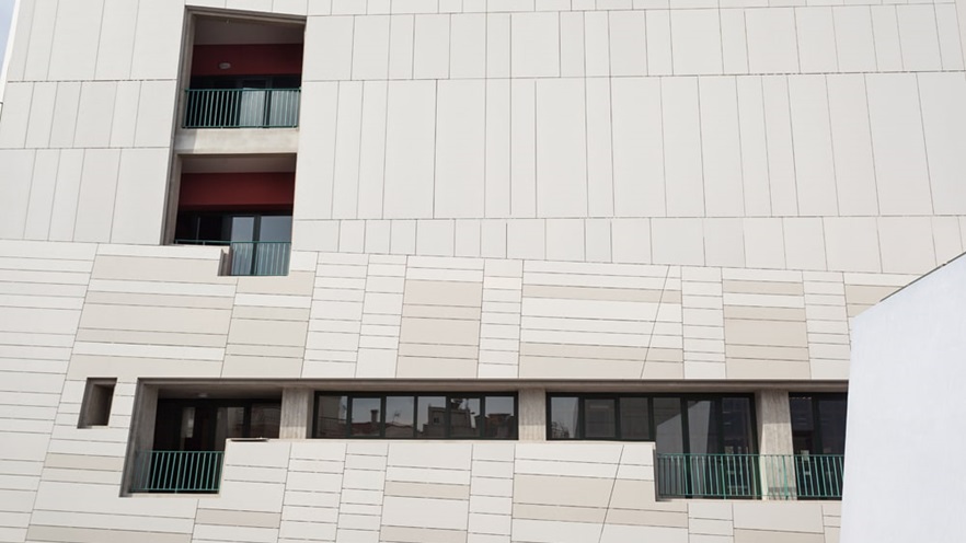 One side of the building with windows and balconies
