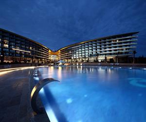 The pool and the building with lights on at night