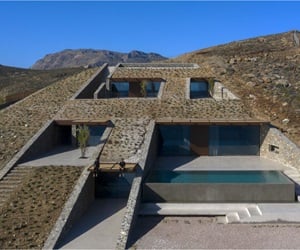 The house is built in the ground, three storeys with windows and a pool appear