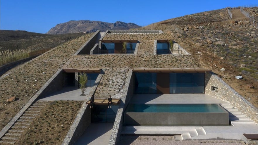 The house is built in the ground, three storeys with windows and a pool appear
