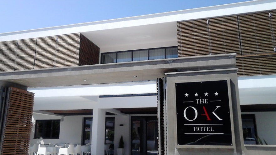 Hotel entrance with black sign and wooden door