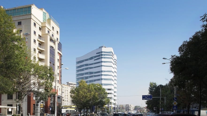 A street with trees and the building in the back