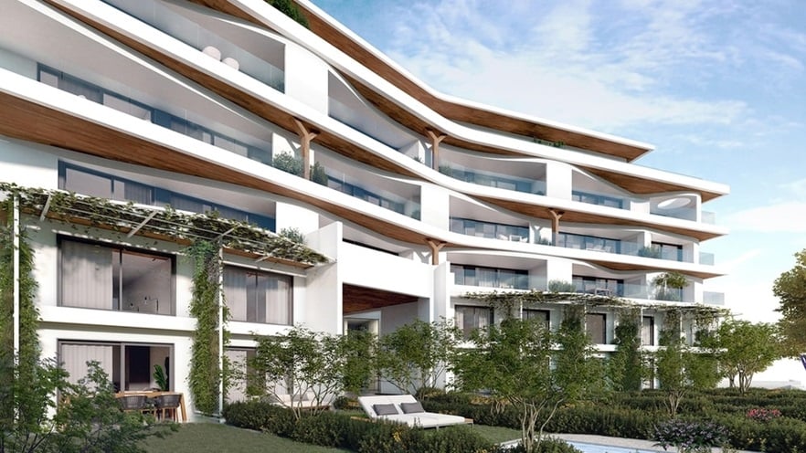 The building has a garden and large windows and balconies