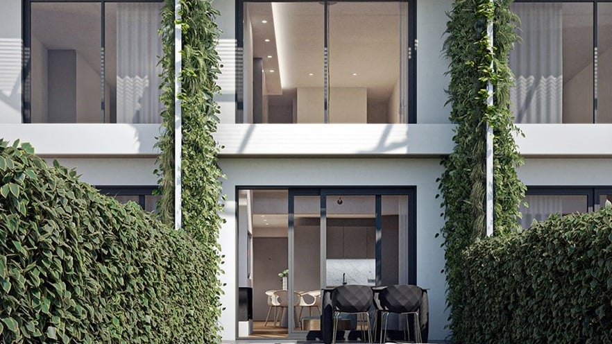The outdoor space has a small terrace and grass