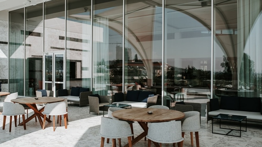 The minimal outdoor dining area in front of the large glass openings