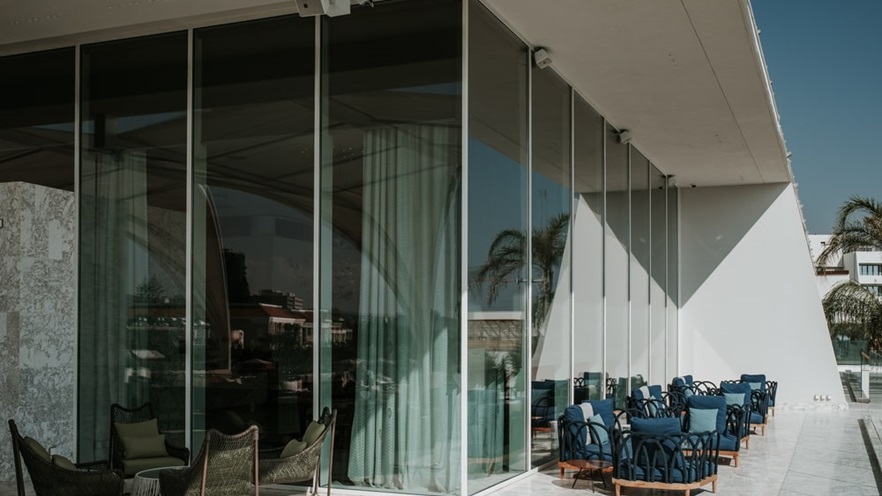 The terrace is equipped with sitting areas in blue tones