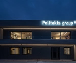 Two-storey building at night with large sign lighted up