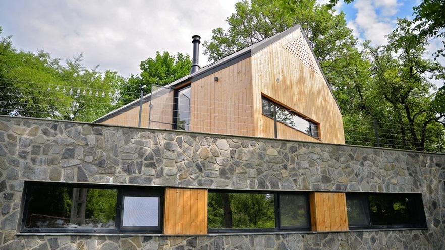 The house is covered in wood and stone on the outside